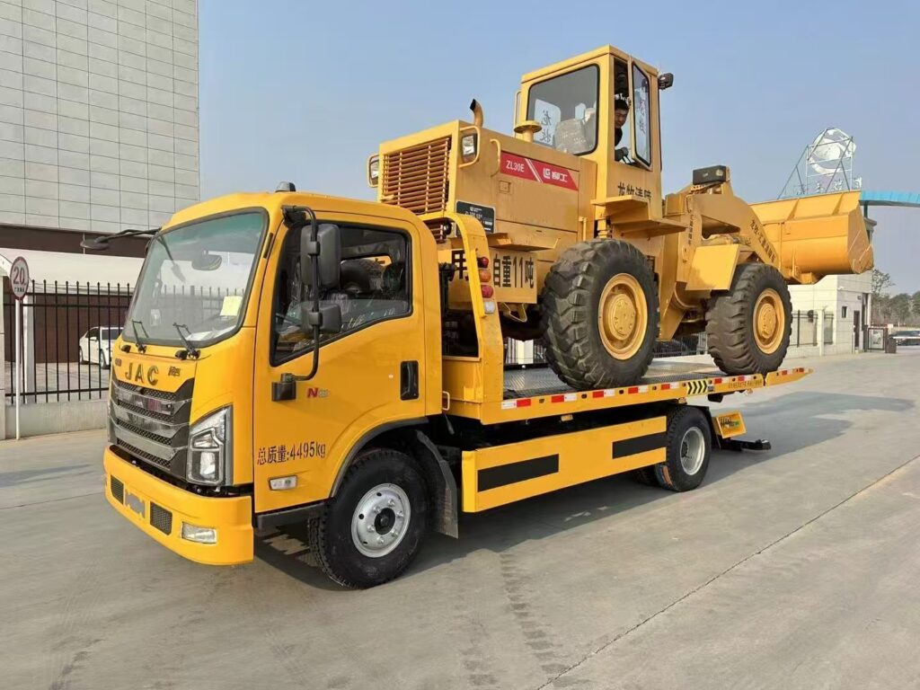 A brand new tow truck carrying an excavator (45-degree view from the left front)