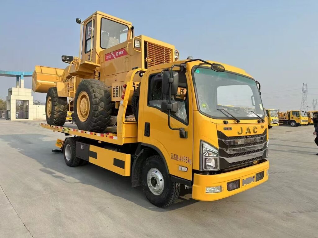A brand new tow truck carrying an excavator (45-degree view from the right front)