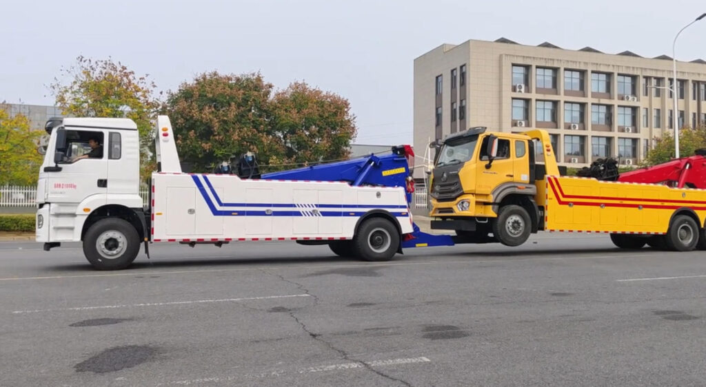 A side view of your heavy-duty Integrated Wrecker towing a heavy-duty Integrated or semi-truck